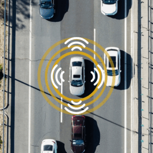 Car drives down highway with graphic overlay of adaptive driving assistance guides.