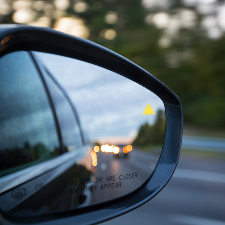ADAS Calibration After an Alignment – Blindspot Monitoring Rearview mirror looking back on a sunset.